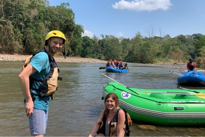 people on shore by plastic inflatable rafts